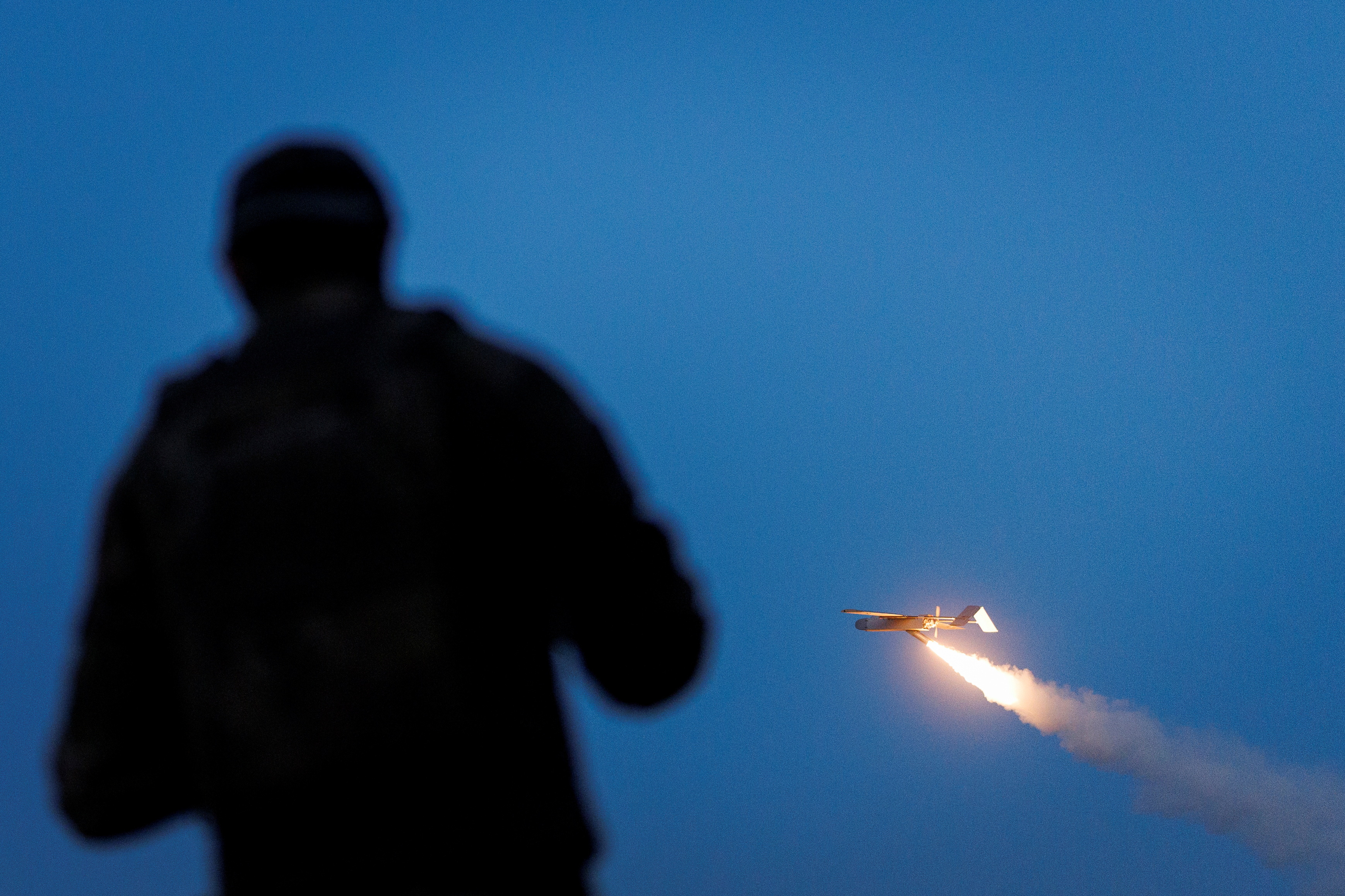 A service member of the Ukrainian Armed Forces looks at an FP-1 deep-strike drone as it launches. (Valentyn Ogirenko/Reuters)
